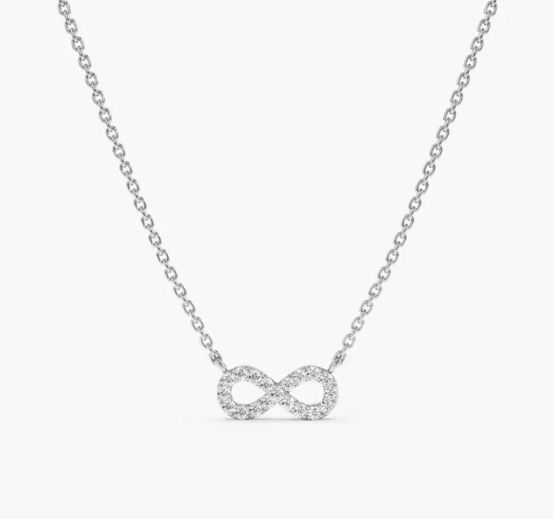 925 sterling silver necklace with cubic zirconia infinity pendant on plain background